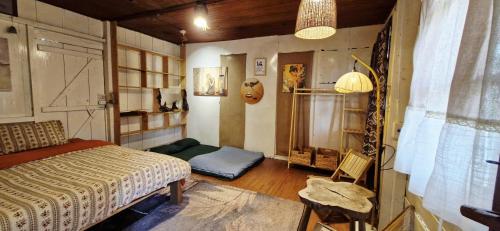 a bedroom with a bed and a chair in it at Nhiên Café & Homestay in Xuân Trường