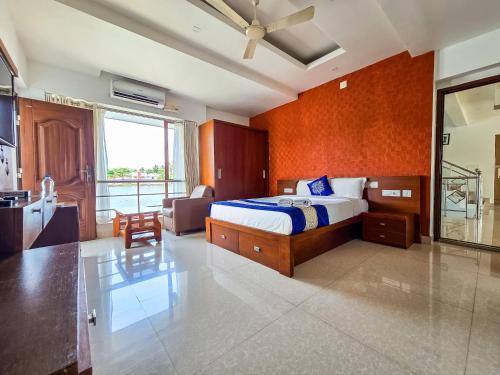 a bedroom with a bed and a living room at Captains Cabin, Alleppey- A Premium Backwater Mansion in Alleppey
