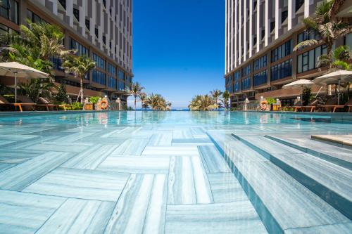 a swimming pool in the middle of a building at Mandala Twilight Haven 5 Star in Phan Thiet