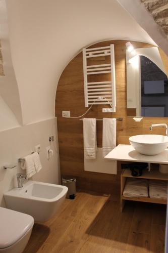 a bathroom with a white toilet and a sink at Suites Anita in Ruvo di Puglia