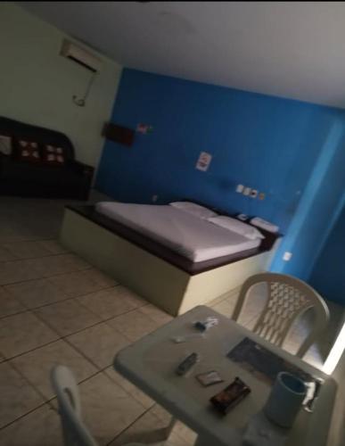 a small room with a small bed and a table at Vamos lá in Caxias das Aldeias Altas