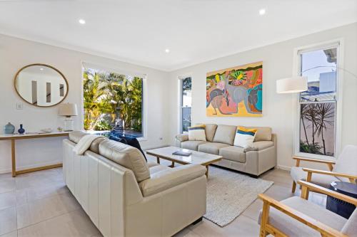 a living room with a couch and a table at The Art House at Beachside in Yaroomba