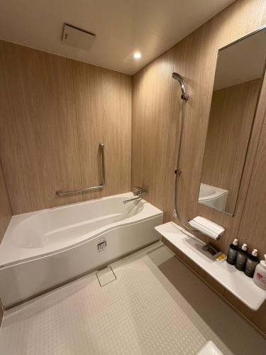 a bathroom with a bath tub and a mirror at Hotel Shindbad Aomori -Love Hotel- in Aomori
