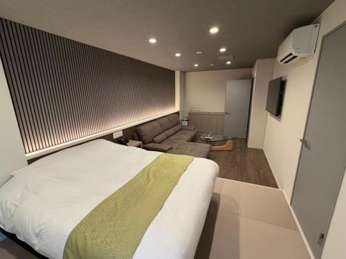 a hotel room with a bed and a couch at Hotel Shindbad Aomori -Love Hotel- in Aomori