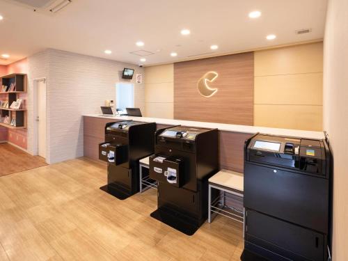 a salon with three printers in a room at Comfort Hotel Hachinohe in Hachinohe