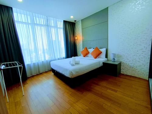 a hotel room with a bed and a large window at VORTEX Suites KLCC Premium BY RRP in Kuala Lumpur
