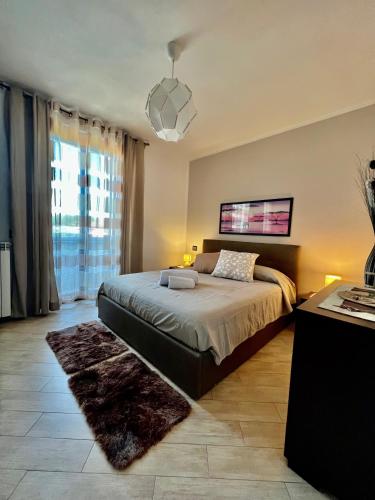 a bedroom with a bed and a large window at Regina House Vigevano in Vigevano