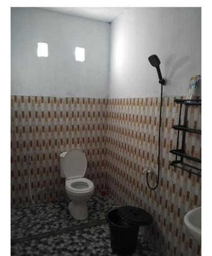a bathroom with a toilet and a shower at STELAMARIS HomeStay in Pulau Bunaken