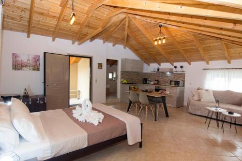 a bedroom with a large bed and a living room at Selinitsa Stone Studio - Mani Seaview Retreat in Agios Nikolaos
