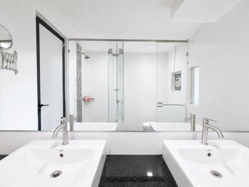 a bathroom with two sinks and a large mirror at Luxury Seaview 2BR Suite Near Georgetown Maritime Penang 0706 in George Town