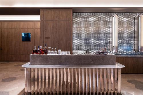 a bar in a room with a tile wall at Orange Crystal Hotel Kunming Haile World in Kunming