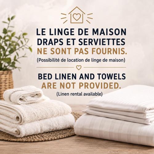 a stack of towels on a table with towels at Maison à 700m de la mer in Bormes-les-Mimosas