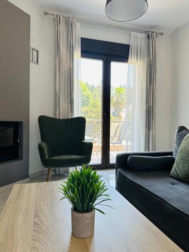 a living room with a couch and a chair and a table at Sunny Siviri in Siviri