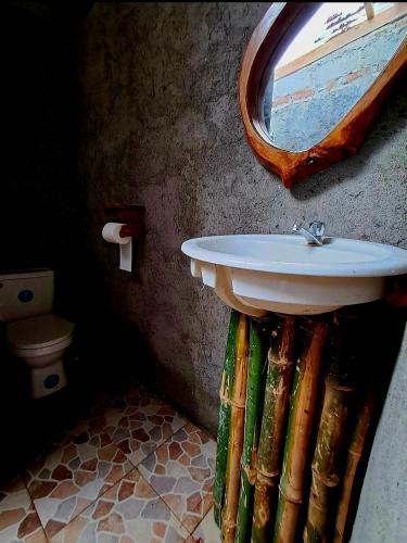 a bathroom with a sink and a mirror at TiKi Hostel Island Ometepe in Rivas