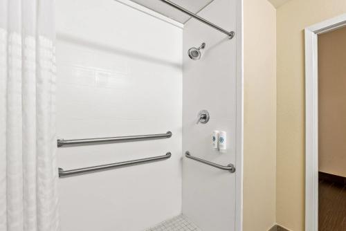 a shower door in a bathroom with a shower curtain at Comfort Inn & Suites Panama City - St Andrew in Panama City