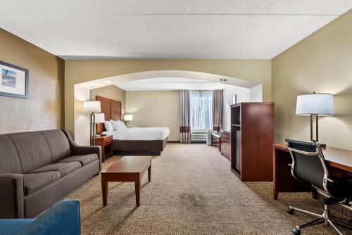 a hotel room with a bed and a couch at Comfort Inn & Suites Panama City - St Andrew in Panama City