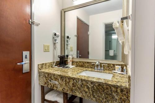 a bathroom with a sink and a mirror at Comfort Inn Garner Clayton I-40 in Edmondson