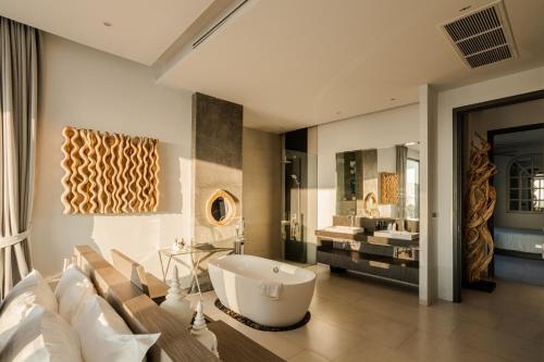 a bathroom with a large tub and a sink at Villa Omari Seaview Pool & Game Room Kata in Kata Beach