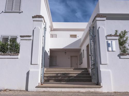 a white house with stairs in front of it at Le Residence del Golfo Orosei in Orosei