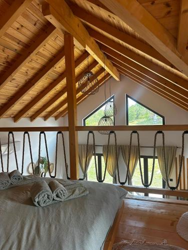 a bedroom with a bed in a room with windows at Montana Goc in Goč