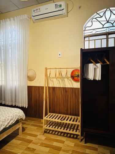 a bedroom with a bed and a window at Phòng Mơ - Nhà Mơ Homestay Bến Tre in Ben Tre