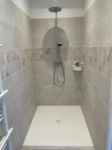 a shower with a shower head in a bathroom at Préchacq-les-Bains in Préchacq