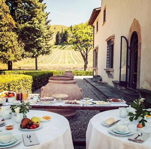 a table with plates of food on top at Castello Pomino in Rufina