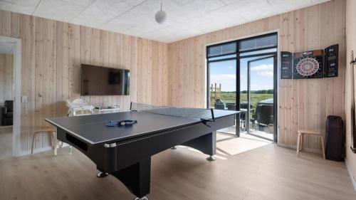a ping pong table in a room with wooden walls at Villavilla 604 - Gjerrild, Østjylland in Grenå