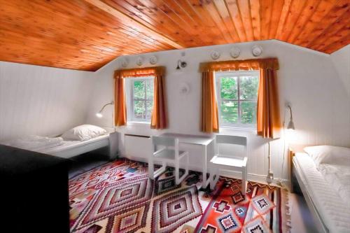 a small room with two beds and two windows at 10081B-Rorvig-Skansehagevej-32 in Rørvig