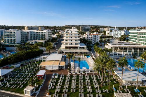 an aerial view of a city with palm trees and buildings at Vrissiana Boutique Beach Hotel in Protaras