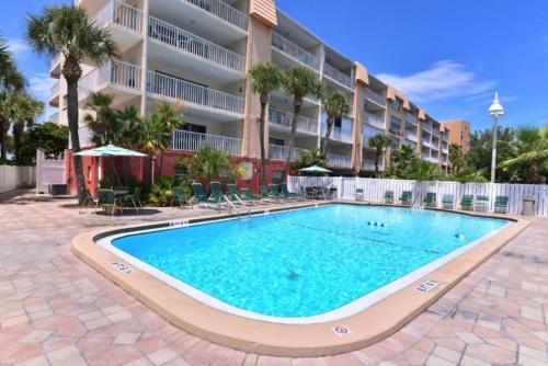 a swimming pool in front of a apartment building at Escape to Beach Oasis! Family Friendly, Updated Beachside Condo with Heated Pool! in Clearwater Beach