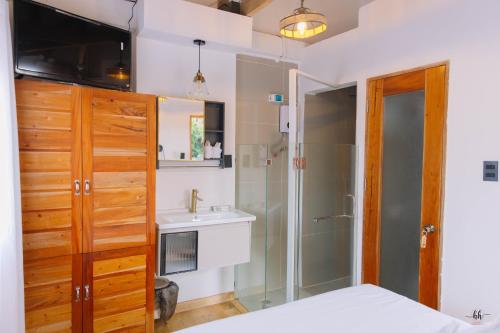 a bathroom with a shower and a sink at Hydrogen Beach Bar and Resort in San Francisco