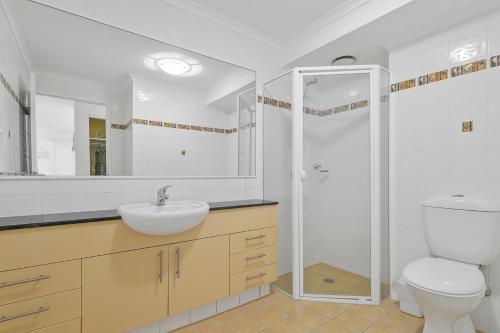 a bathroom with a toilet and a sink and a shower at Flightdeck 101, Clarence Street in Port Macquarie
