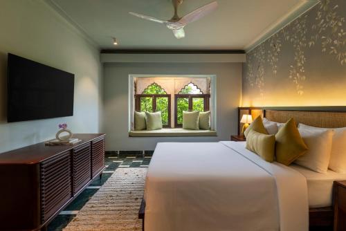 a bedroom with a large bed and a window at YAAN Udaipur in Udaipur
