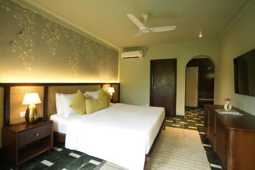 a bedroom with a bed and a ceiling fan at YAAN Udaipur in Udaipur