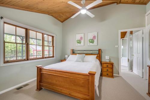 a bedroom with a bed and a ceiling fan at Historic Huntingdon House in Wauchope