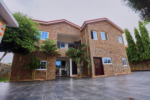 a large brick building with a driveway in front of it at Douglas Luxury Apartments - Douglas Court in Trofwi
