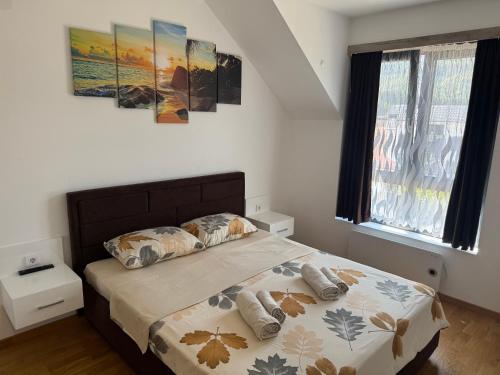a bedroom with a bed with two pillows on it at APARTMaN HAPPY PLACE in Soko Banja