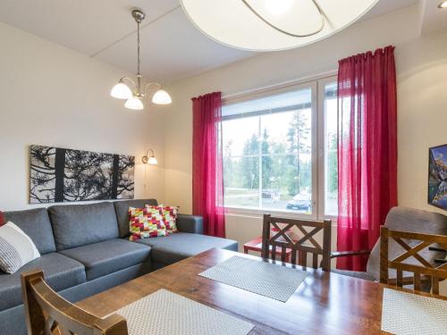 a living room with a couch and a table at Holiday Home Yllästar 3 as 508 by Interhome in Äkäslompolo