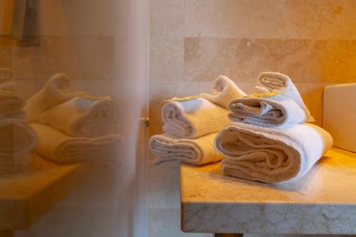 a pile of towels sitting on a counter in a bathroom at Terme Di Venturina - Toscana in Venturina Terme