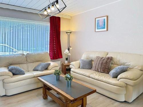 a living room with two couches and a coffee table at Holiday Home Ruiterlaan with parking by Interhome in Bredene