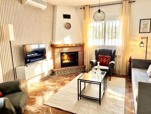 a living room with a couch and a fireplace at Casa rural Lomalinda in Granada