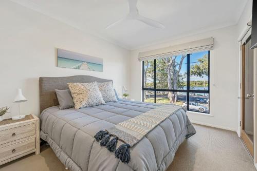 a bedroom with a bed and a large window at Pippies, your water view escape in North Haven