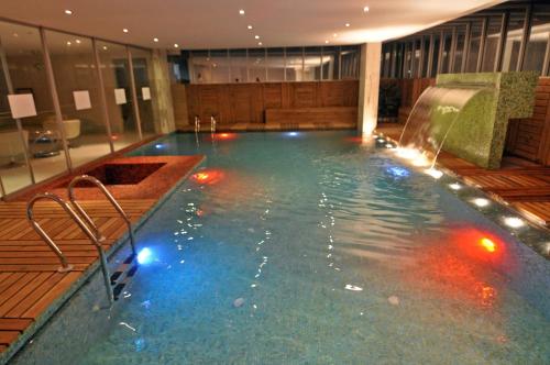 a swimming pool in a hotel with lights in it at Contemporary Heights Hotel and Apartments in Dhaka