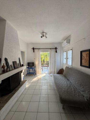 a living room with a couch and a table at Serene appartment at St. Ioannis in Agios Ioannis Pelio
