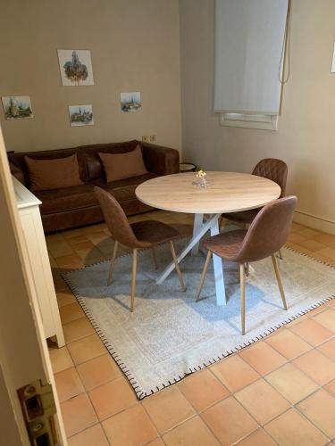 a table and chairs in a living room at CH Apartments Boutique in Seville