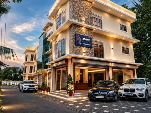 two cars parked in front of a building at 3BHK Villa 15 min Thommankuthu Falls Groups in Thodupuzha