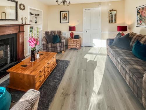 a living room with a couch and a table at 10 The Apostles - Uk37312 in Lochranza