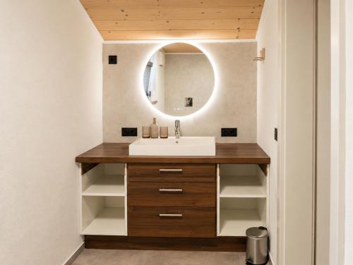 a bathroom with a sink and a mirror at Toms ONE in Saalfelden am Steinernen Meer