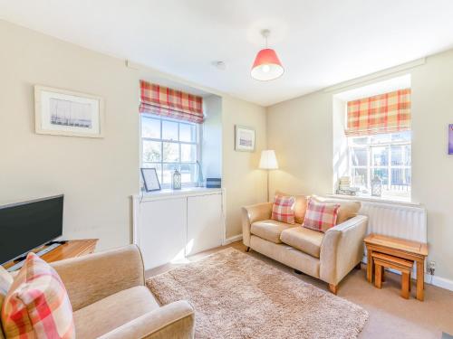 a living room with two chairs and a television at South Lodge - Uk48318 in Berwick-Upon-Tweed